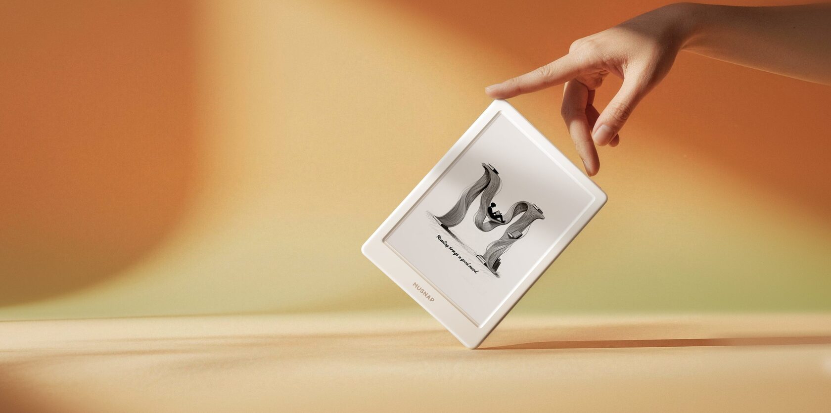 MUSNAP E-Ink device — hand touching the screen