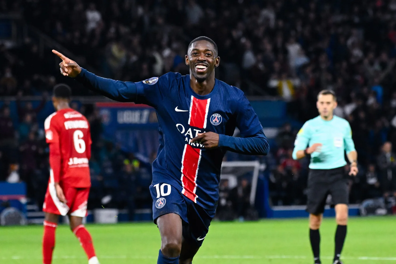 PSG forward Ousmane Dembélé smiling and celebrating a successful play during the match against Lille