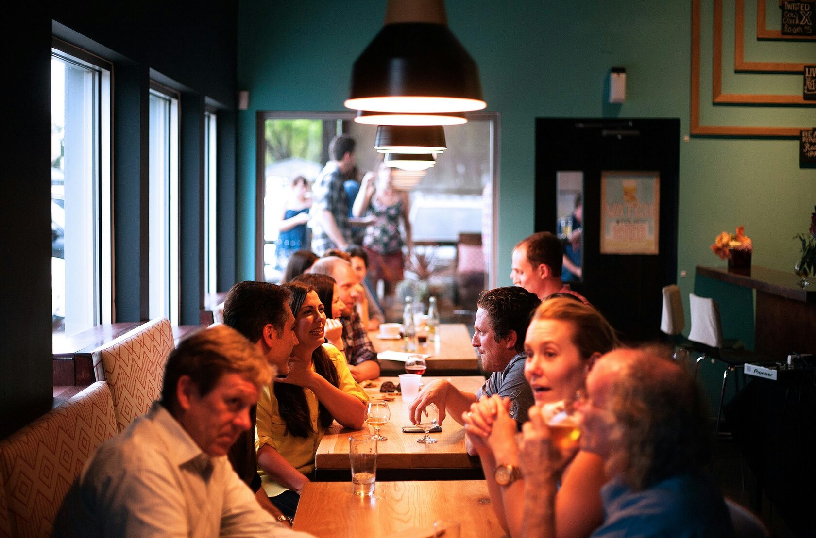 Full restaurant dining room during Friday evening service in Italy