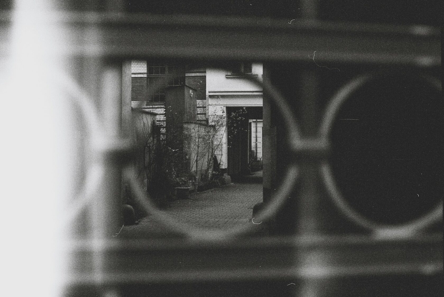 Cinematic still — house courtyard, black and white