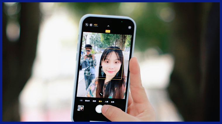 Person taking a selfie with a smartphone, illustrating the One2Fan creator platform and user experience.