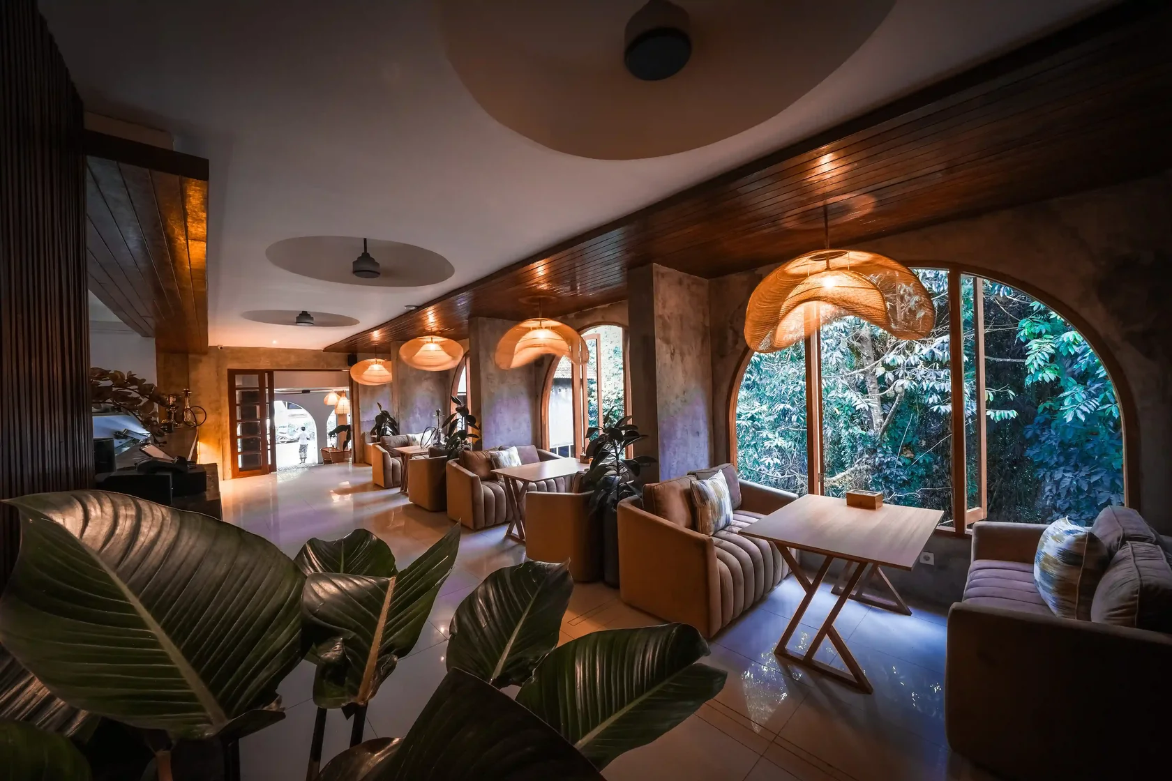 The warm and intimate interior of Eden Hookah Club Ubud, featuring a unique view of a lush forest, an ideal place to sample top best tobaccos for your shisha.