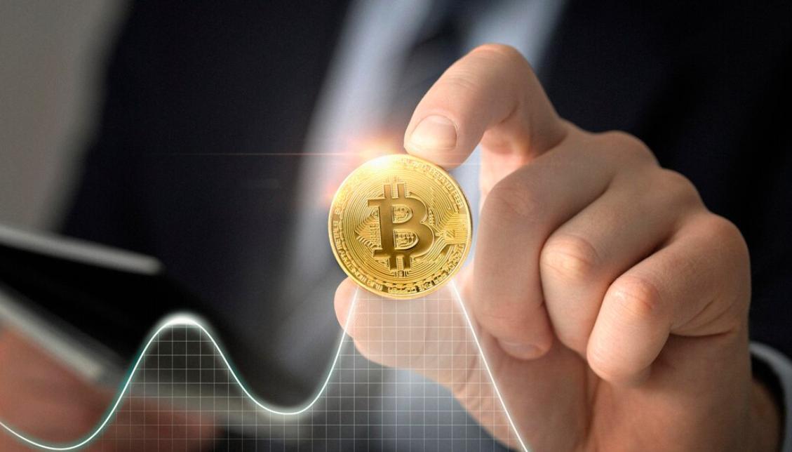 Bitcoin volatility: Person holding Bitcoin and illustration of a line chart