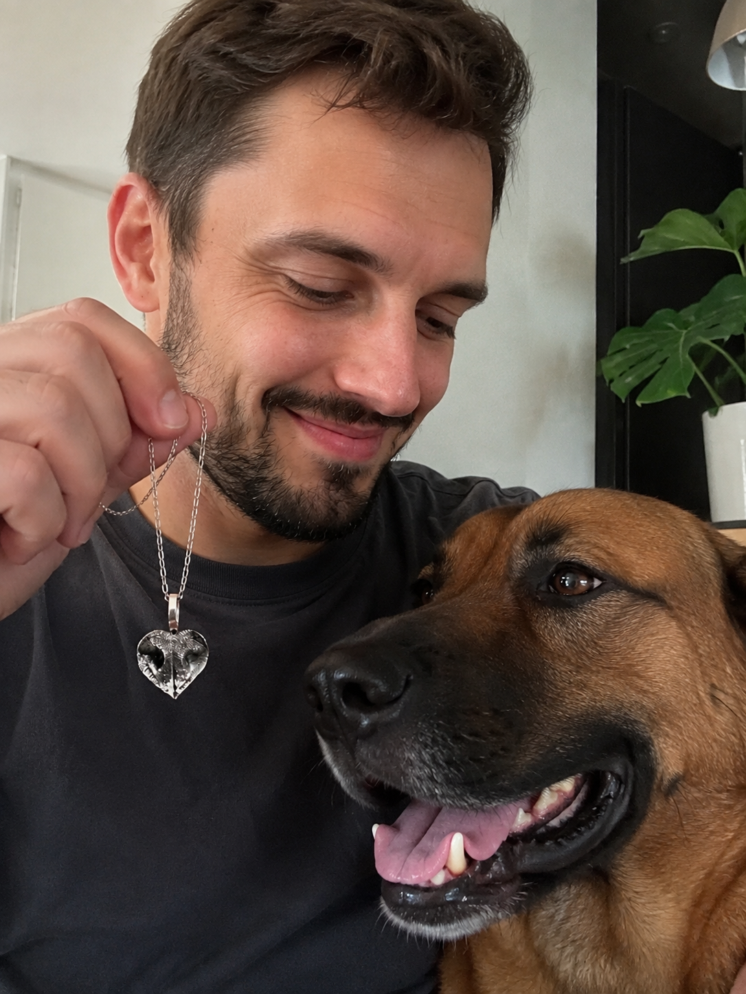 Улыбающийся мужчина рядом с бельгийской овчаркой