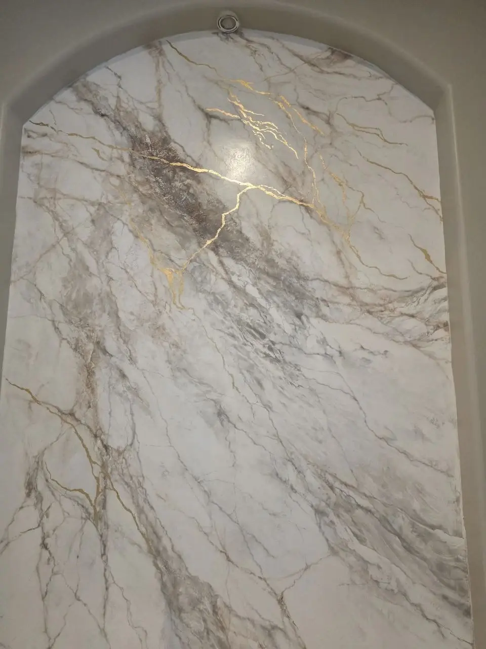 Detailed view of a completed Venetian plaster feature inside an arched niche in Lakewood Ranch.