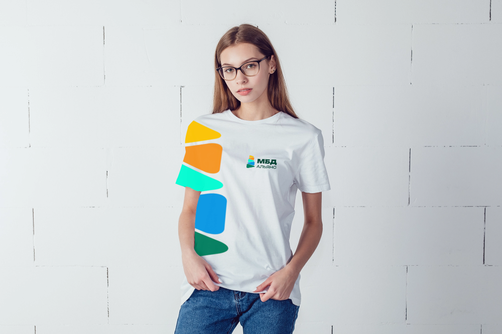 Логотип МБД Альянс на футболке. На рукаве — увеличенный графический элемент в виде цветной стрелки.