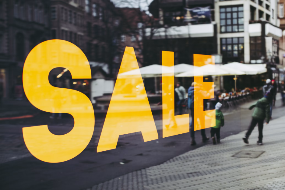 Sale sign on a retail store window representing Black Friday 2026 shopping promotions