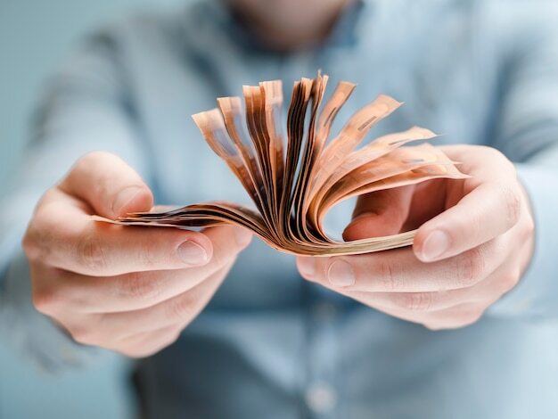 Front view of person holding money