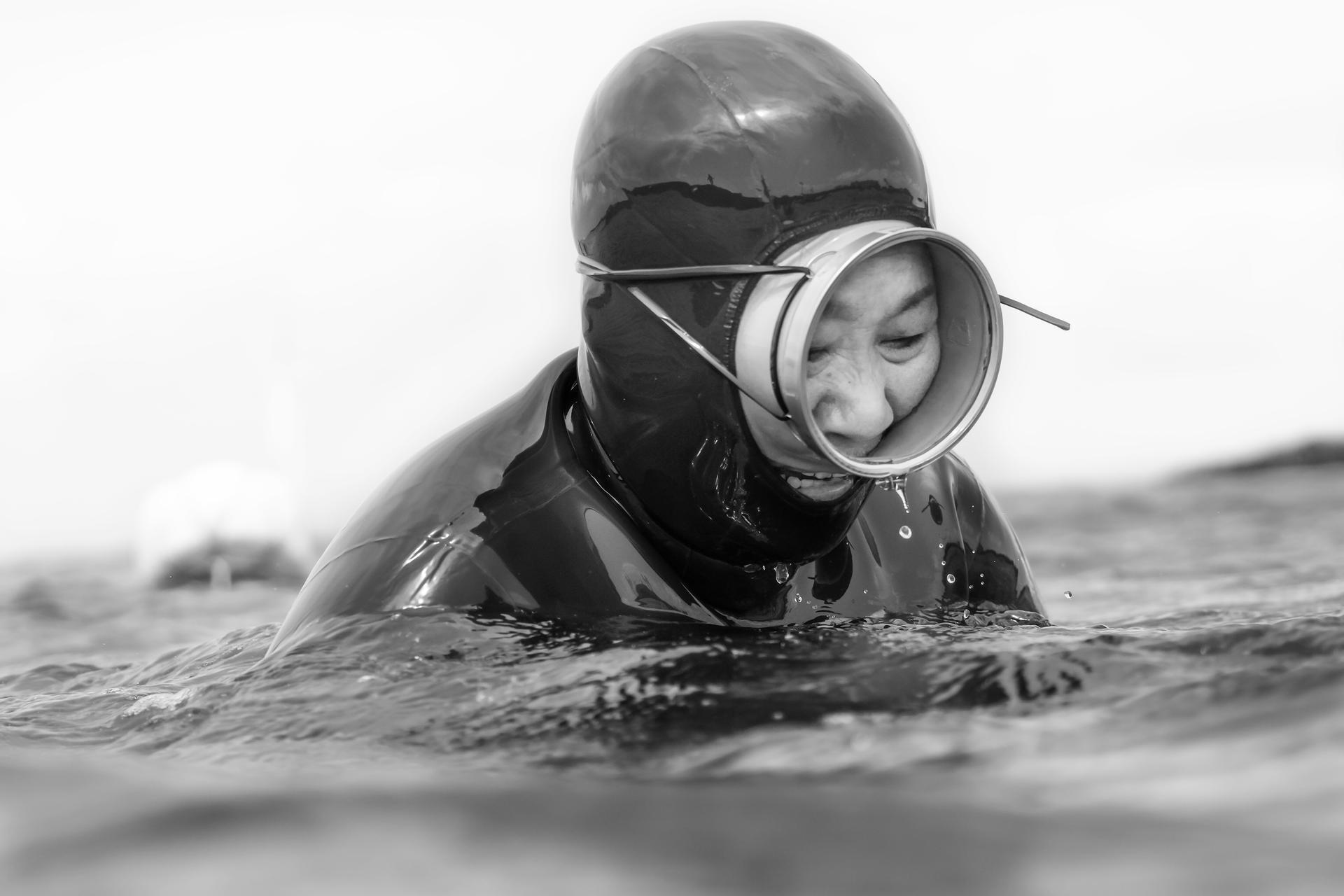 South Korea | Jaime Gomez. A haenyeo diver prepares to enter the water in search of shellfish, continuing a centuries-old tradition on Jeju Island.