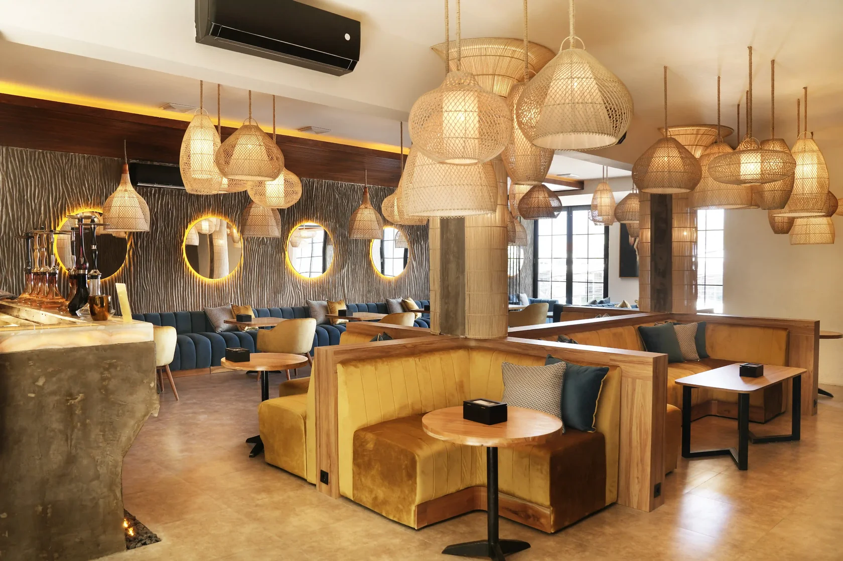 Eden Hookah Club Uluwatu interior with cozy seating and warm woven pendant lights