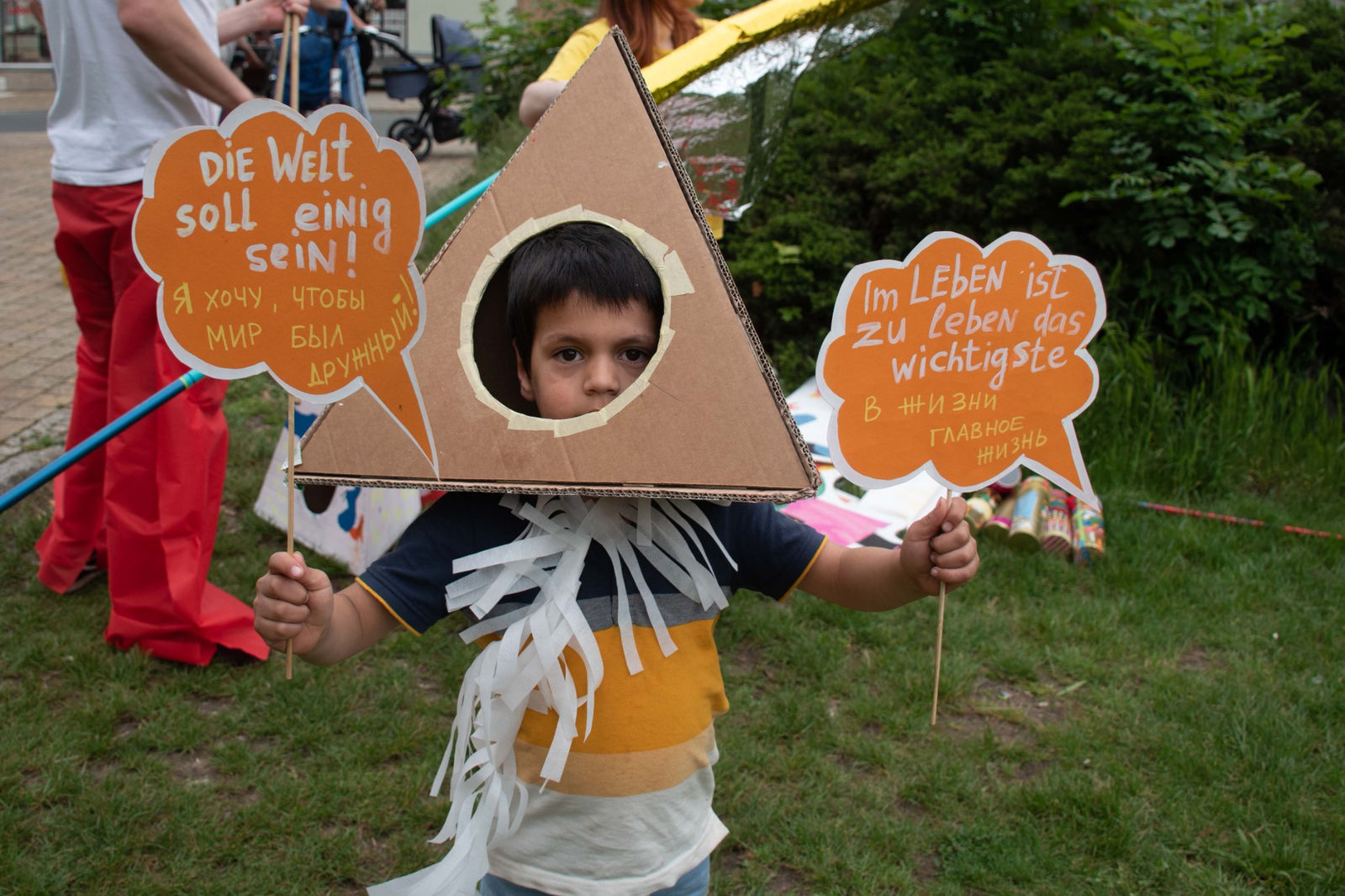 A child in a cardboard costume with hand-painted signs