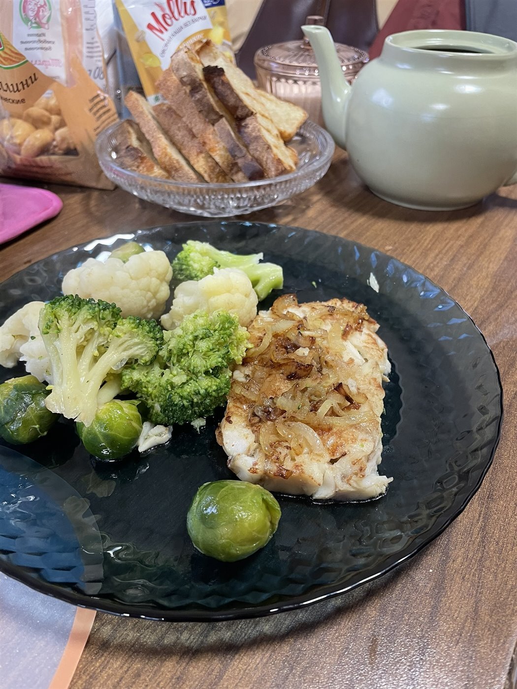 A teapot and food on a shared table