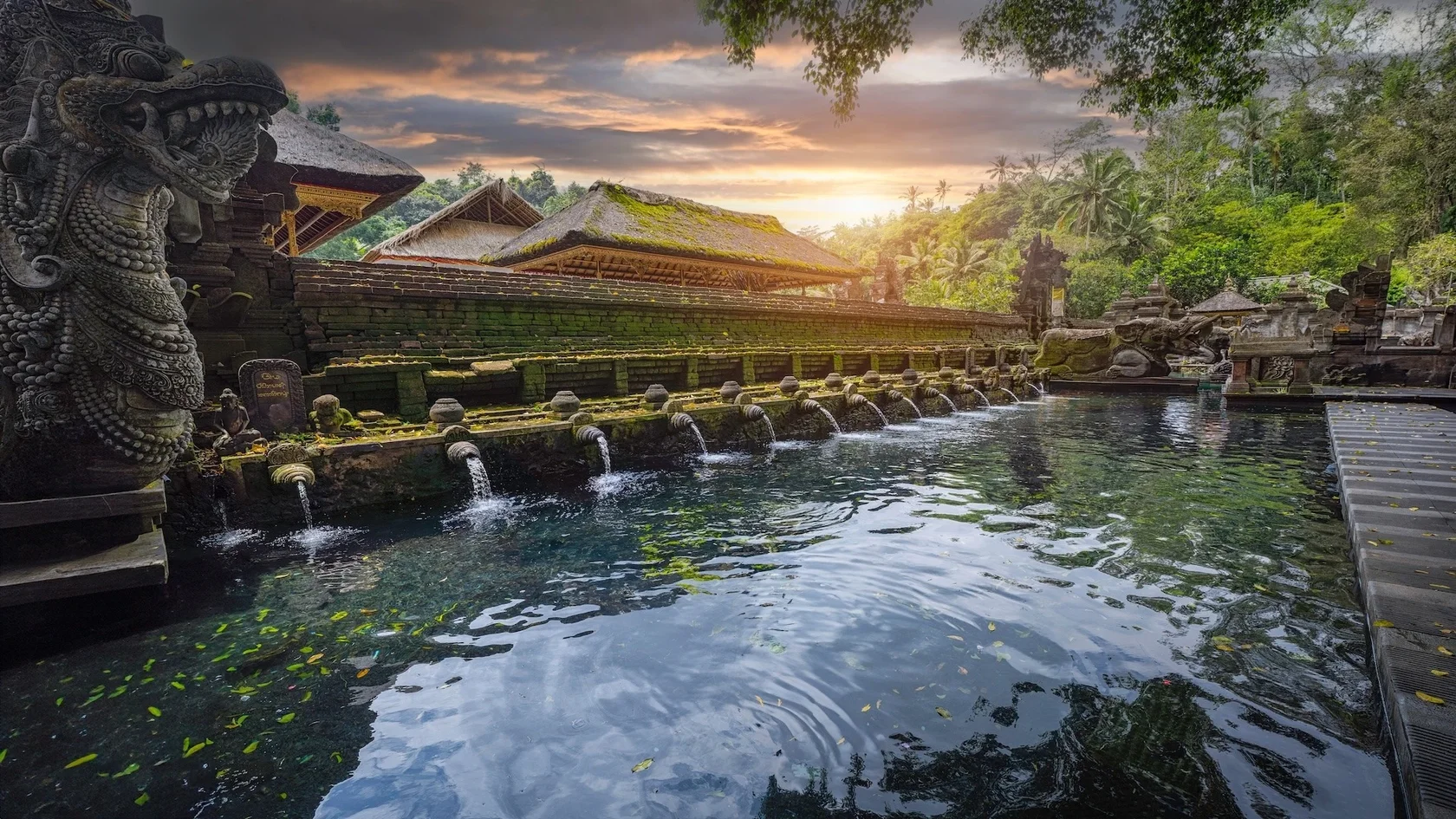 Devotees performing the Melukat purification ritual in the holy springs of Tirta Empul, a renowned Bali sacred location.