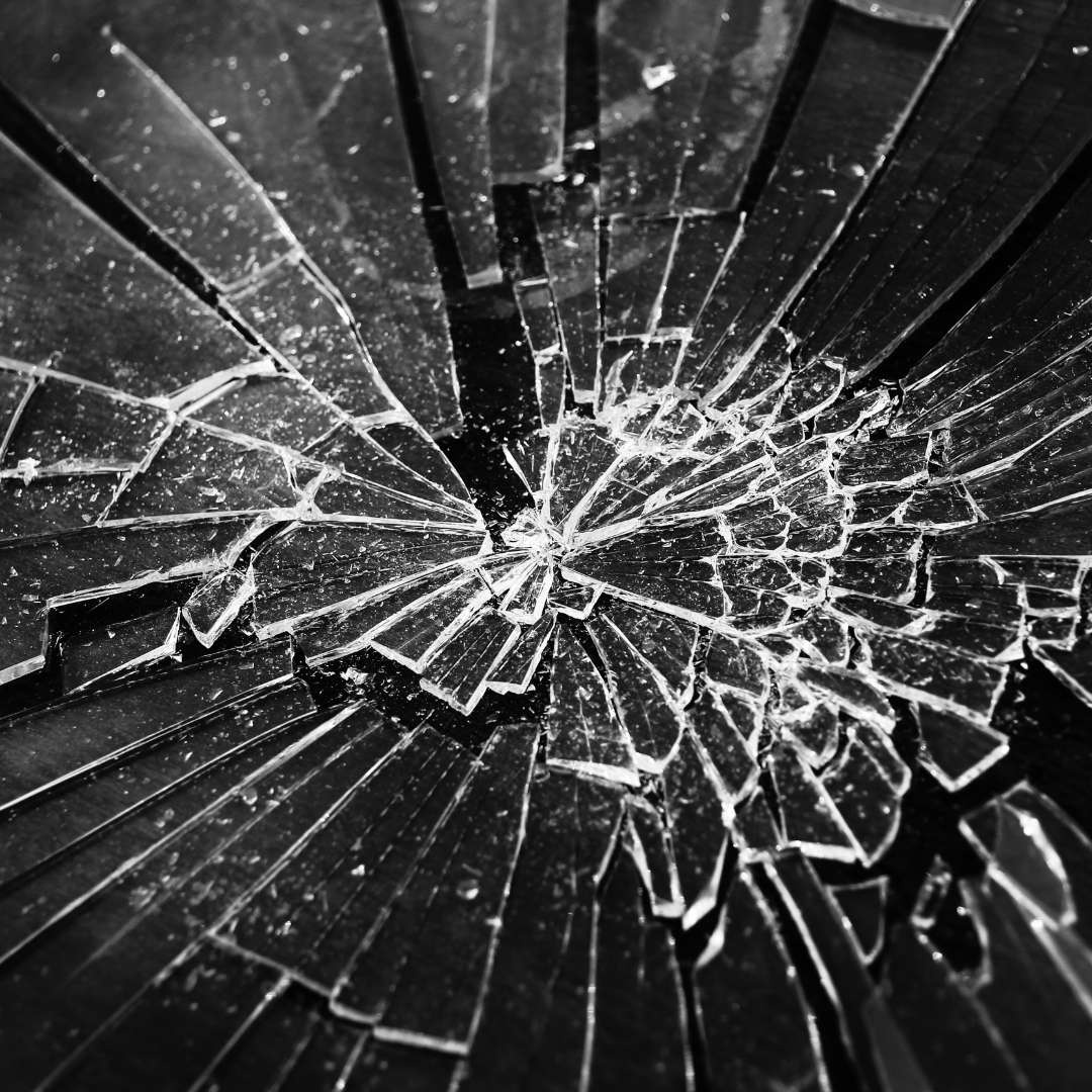 a black and white photograph of a broken glass