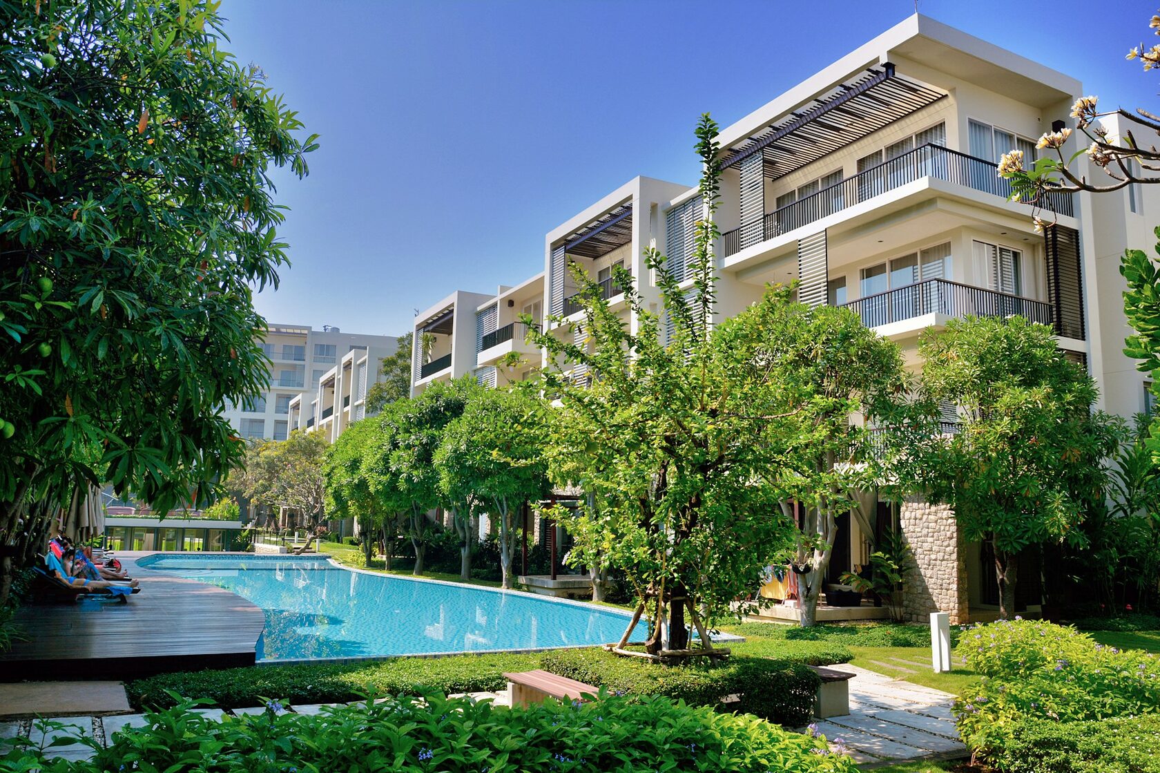 Resort-style apartment complex with tropical pool