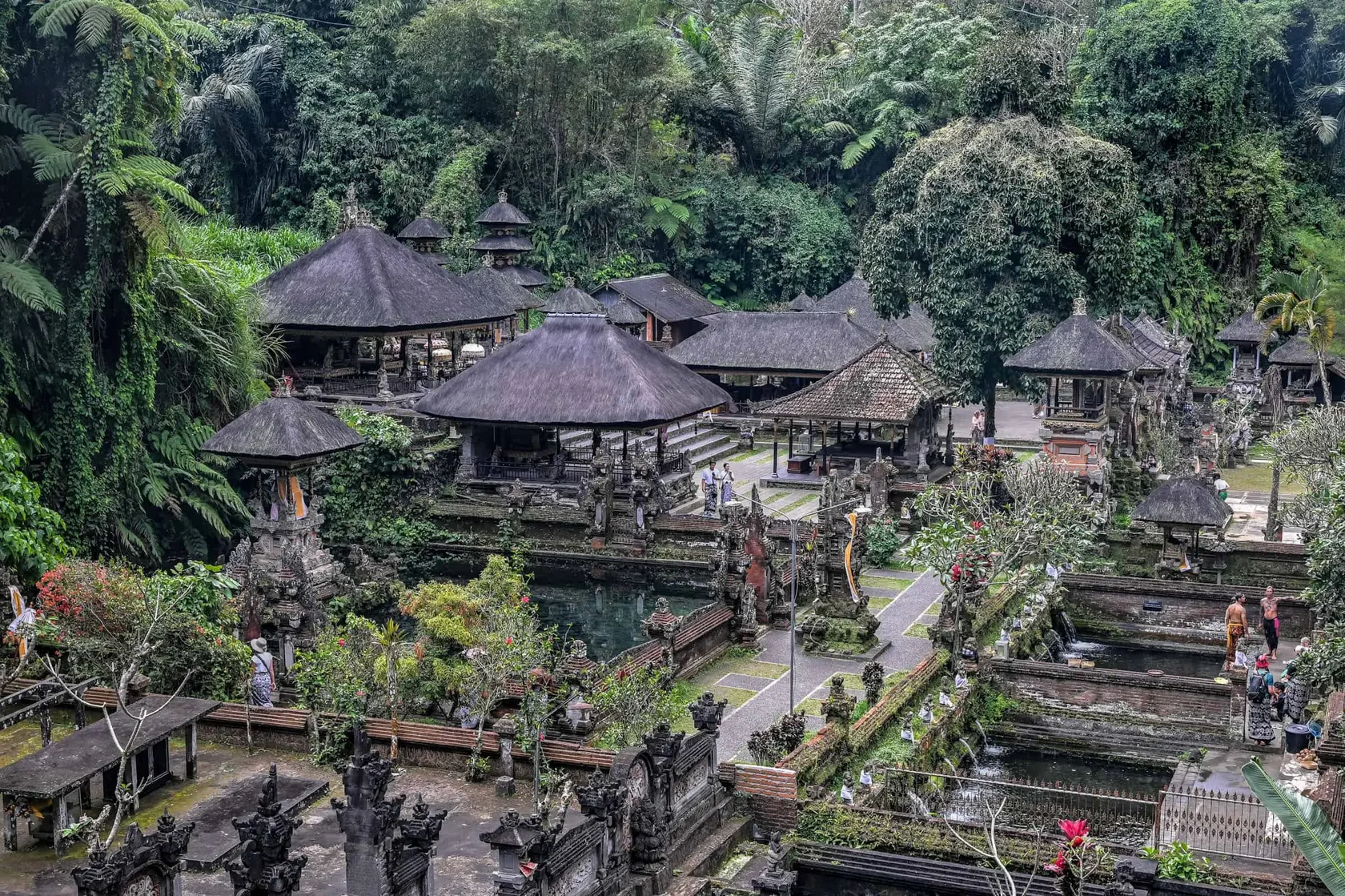 Ancient shrines carved into the rock face at Gunung Kawi, a serene Bali sacred location in the Pakerisan river valley.