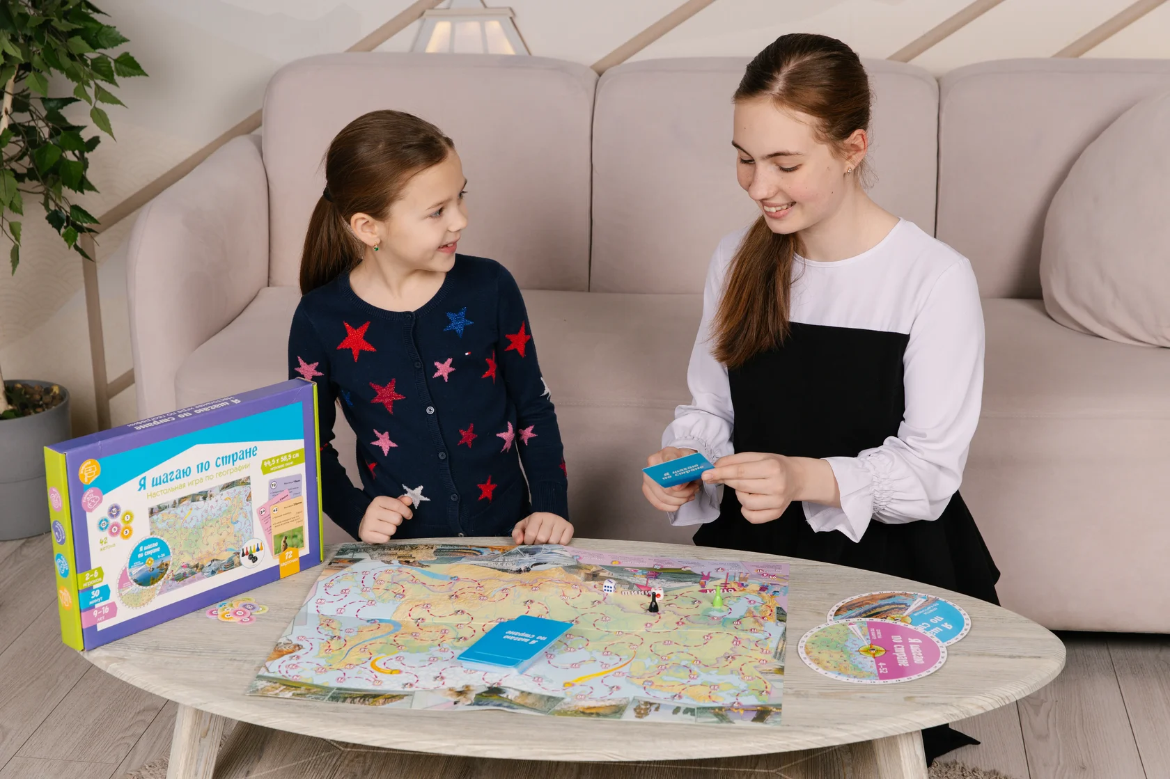 Девочка и взрослая играют в настольную игру «Игротеки»