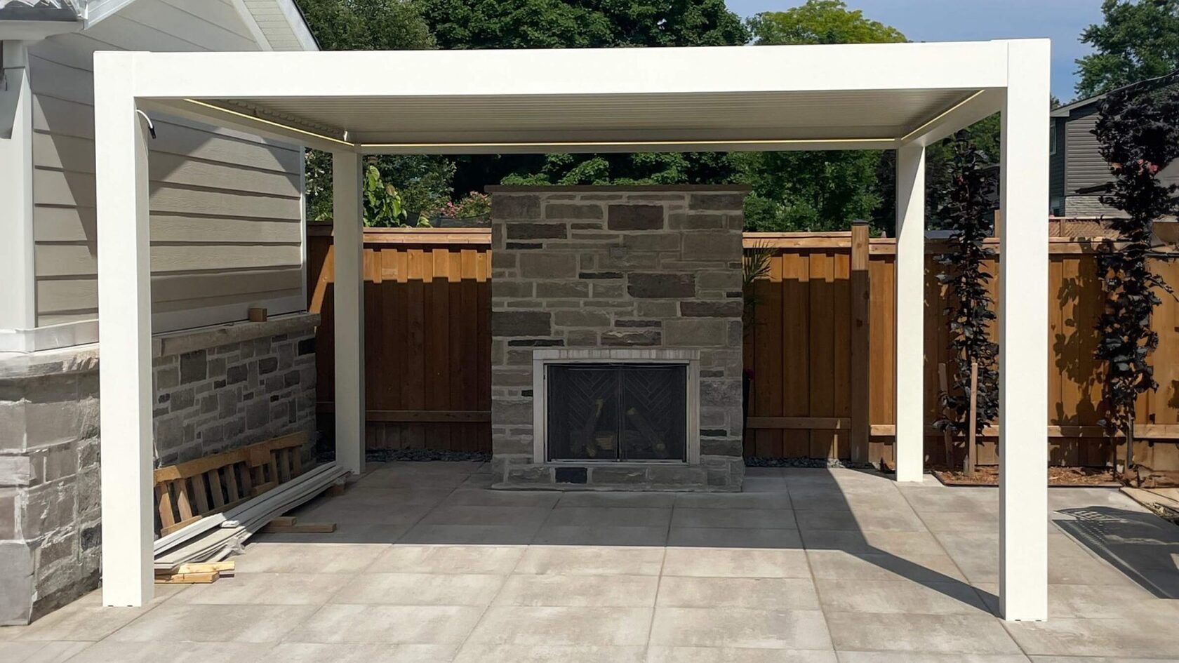 White aluminum pergola structure in progress, permit-ready construction stage