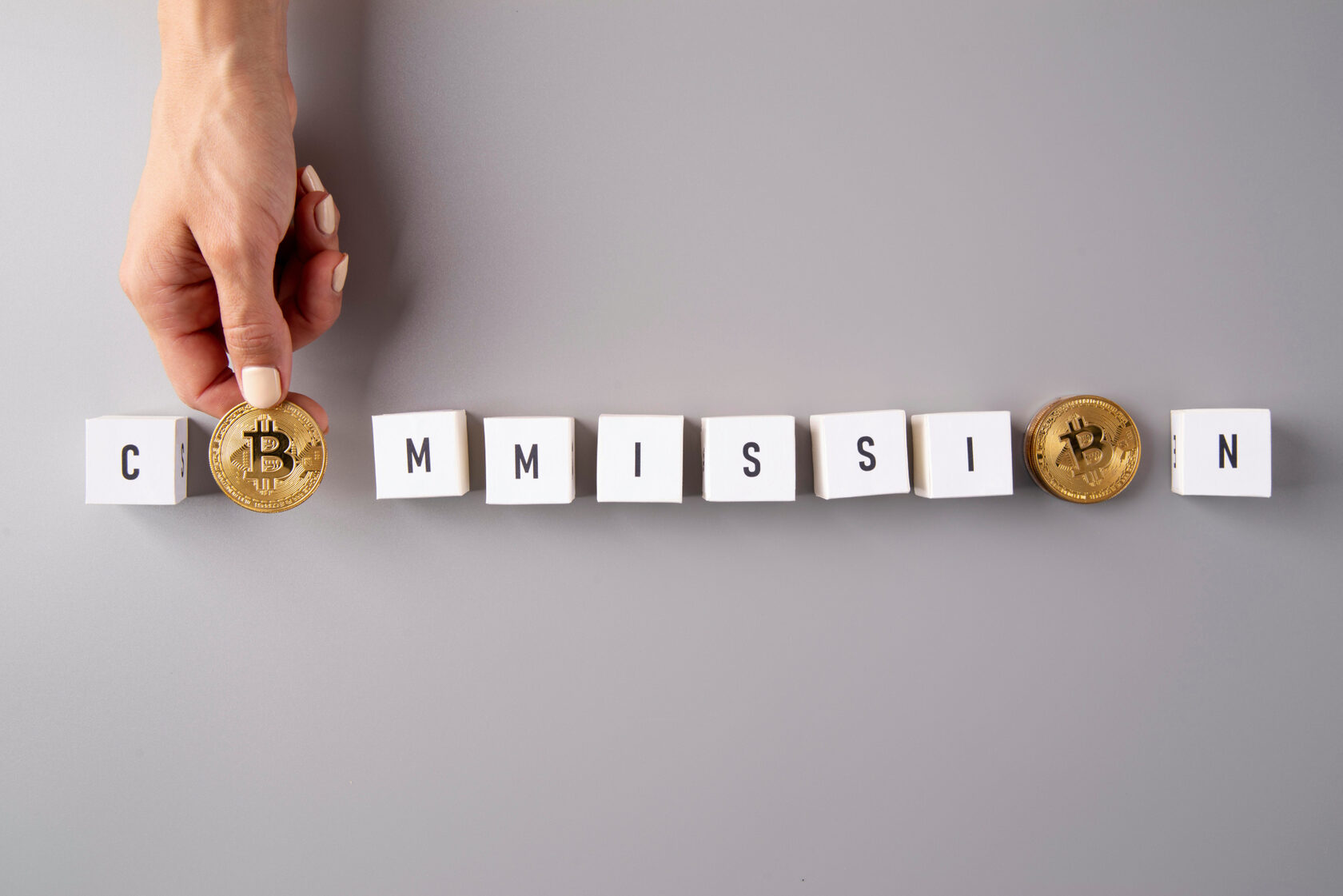 Palabra “commision” con monedas de bitcoin para simbolizar comisiones Binance