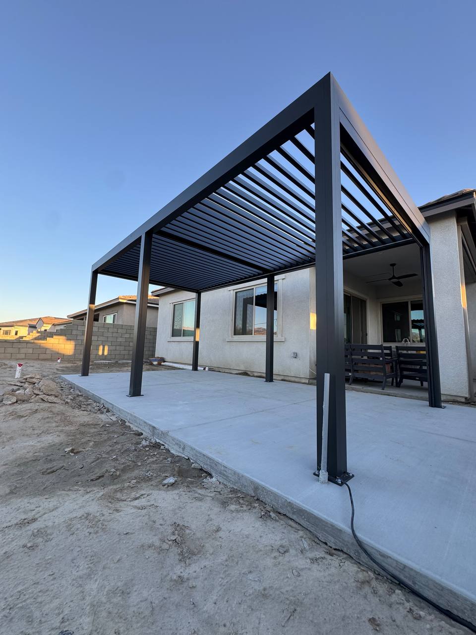 Completed 10 by 19 ft motorized aluminum pergola in Yorba Linda with louvers open