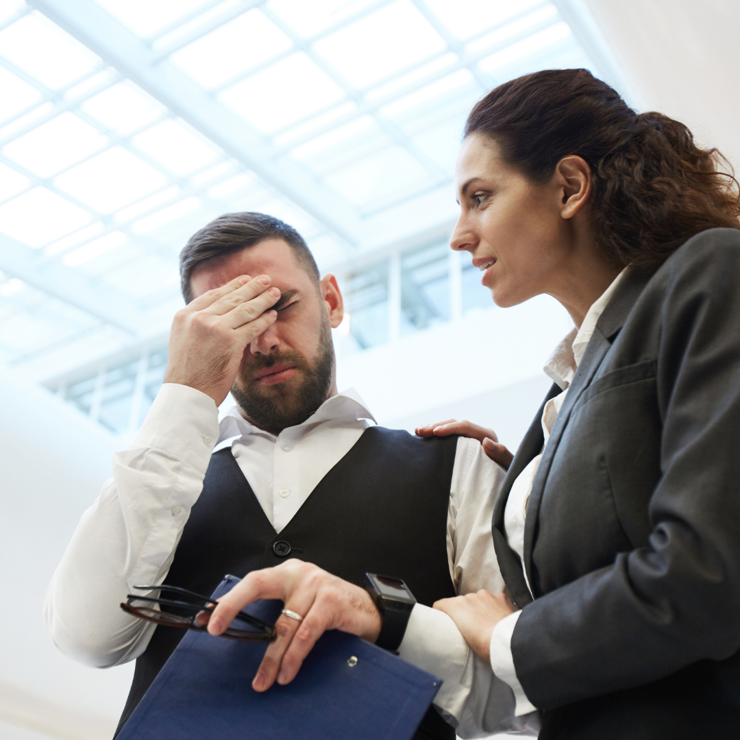 a person in business attire is looking at another person