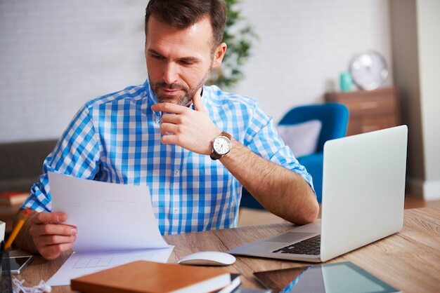 Business person reading important documents at his desk