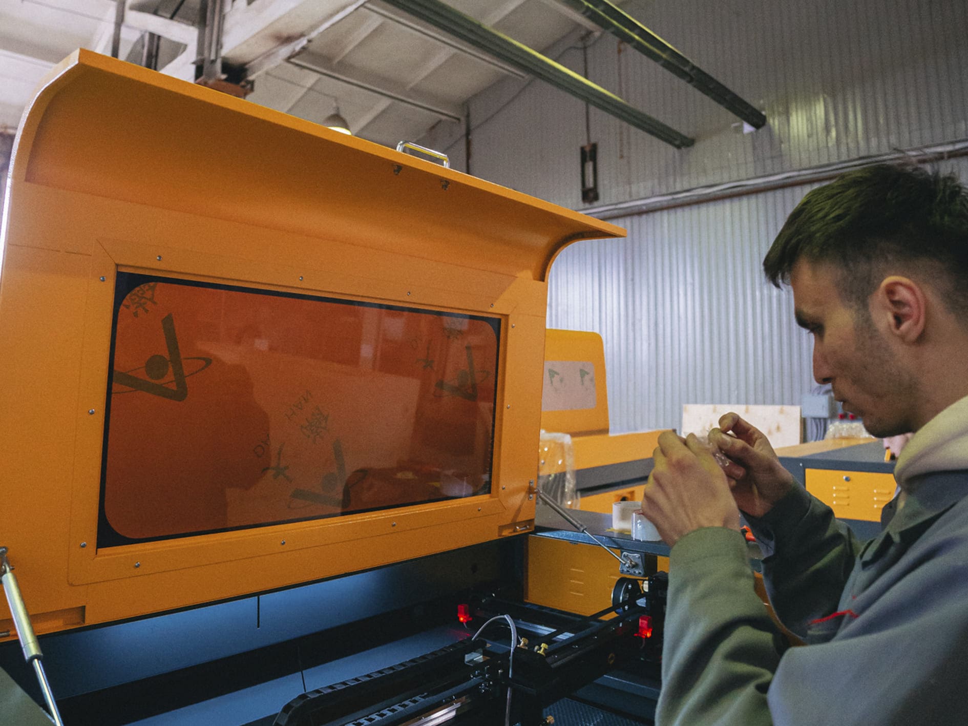 Сотрудник настраивает станок