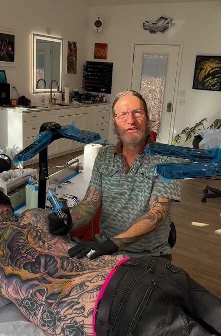 Tattoo artist Guy Aitchison does an organic-style full-body tattoo on a man in his studio. Los Angeles
