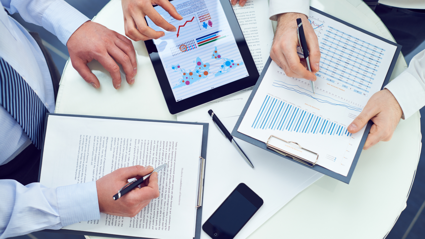 Professionals preparing financial documents for a lender meeting.