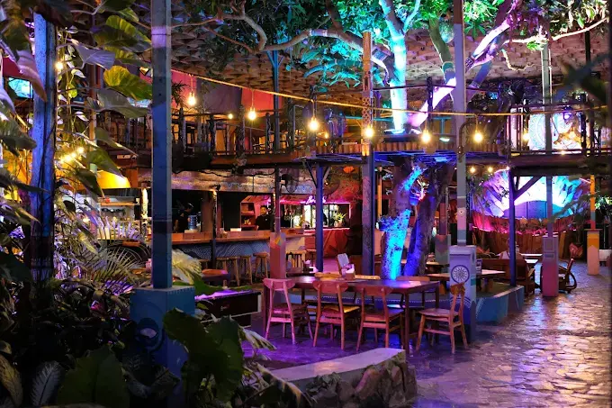 The colorful, neon-lit treehouse interior of Hatch Uluwatu, bringing an eccentric, psychedelic energy to the lineup of the best bars in Bali.