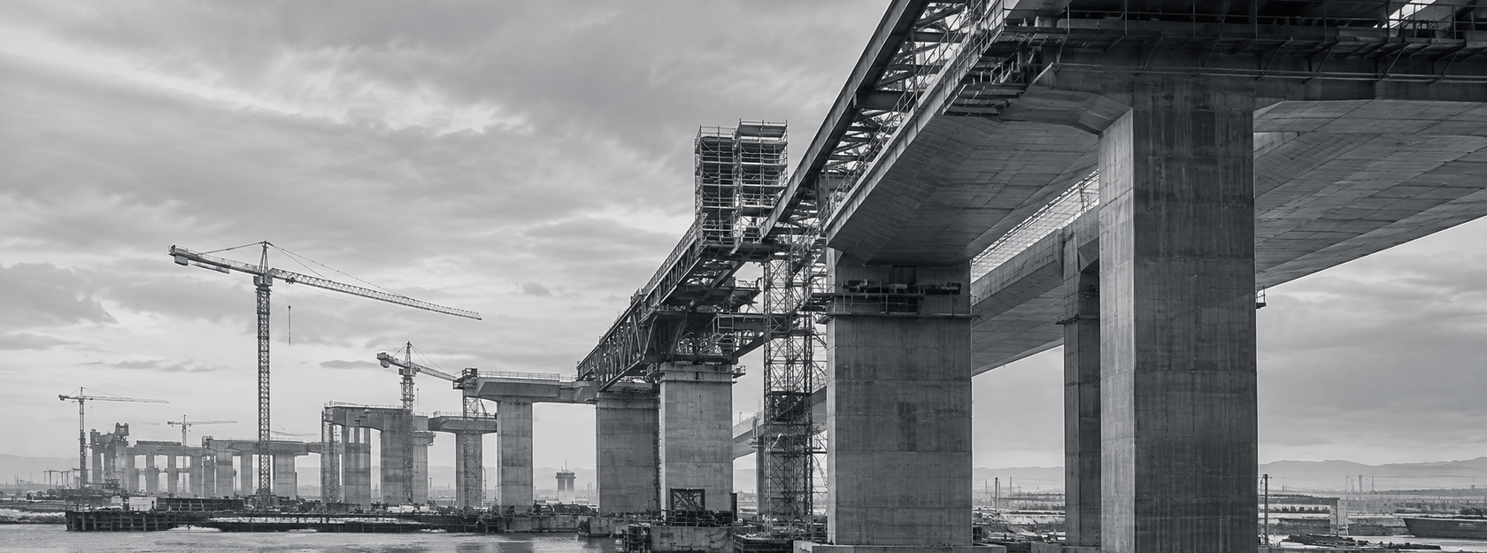 Infrastructure construction project with concrete bridge structures and cranes