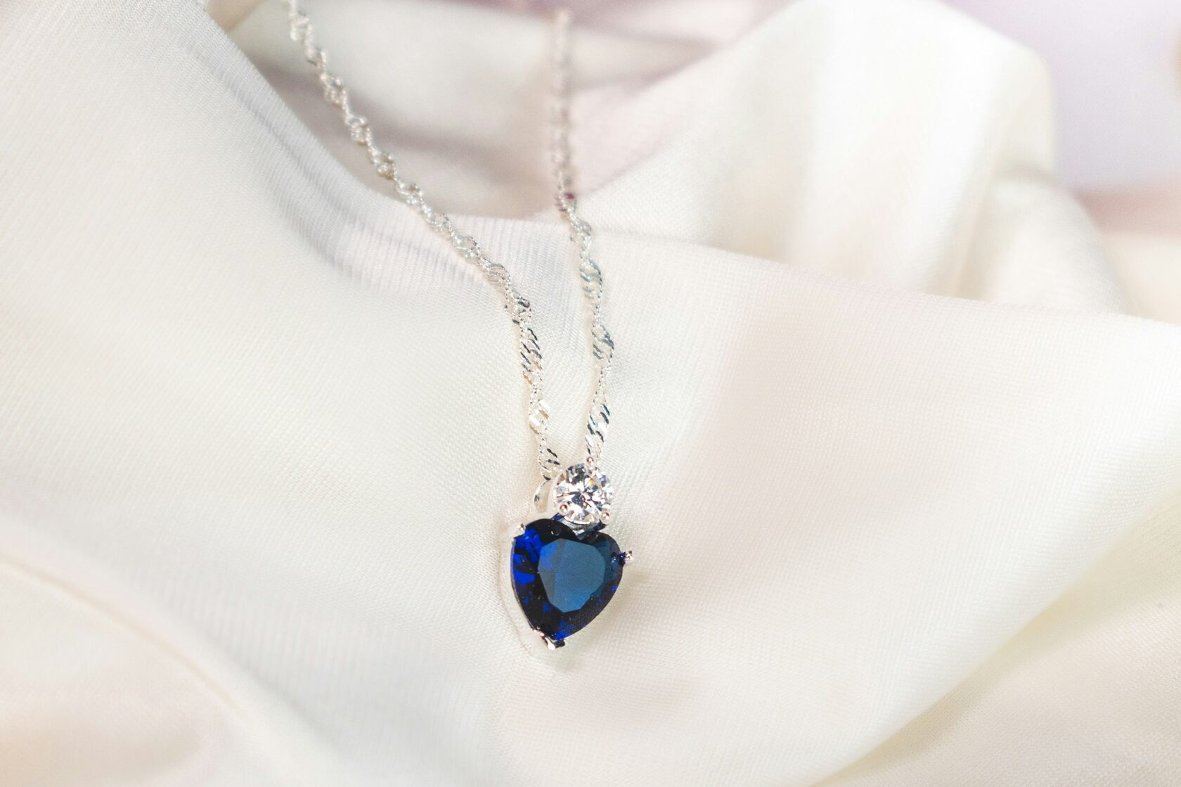 Delicate sapphire pendant necklace on marble slab