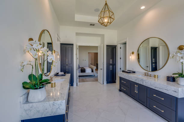 Symmetrical vanity areas in master bathroom Newly built home with beautiful long bathroom with free standing bathtub bathroom remodeling  stock pictures, royalty-free photos & images