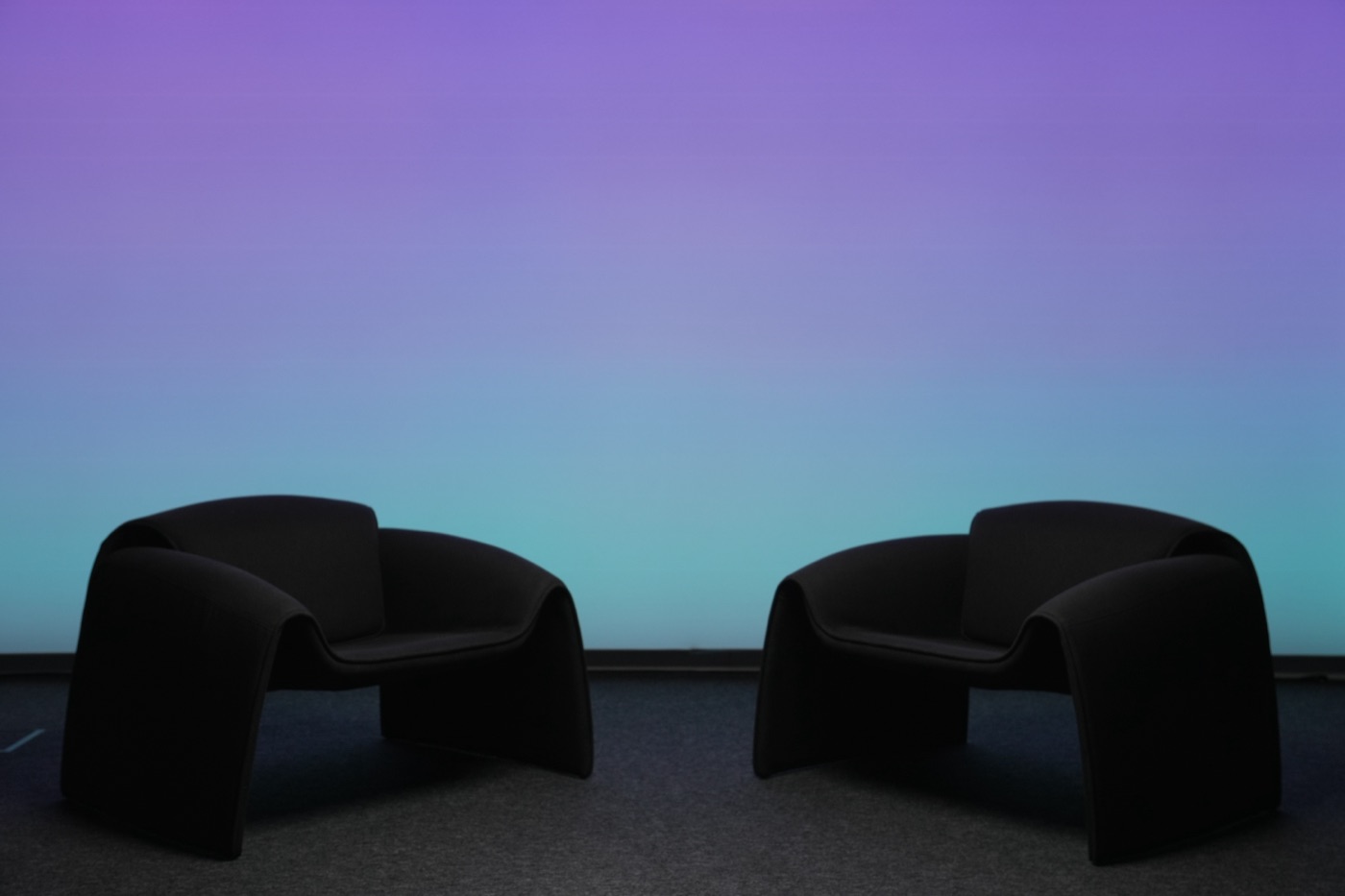 Studio wall lit in a teal-to-purple gradient