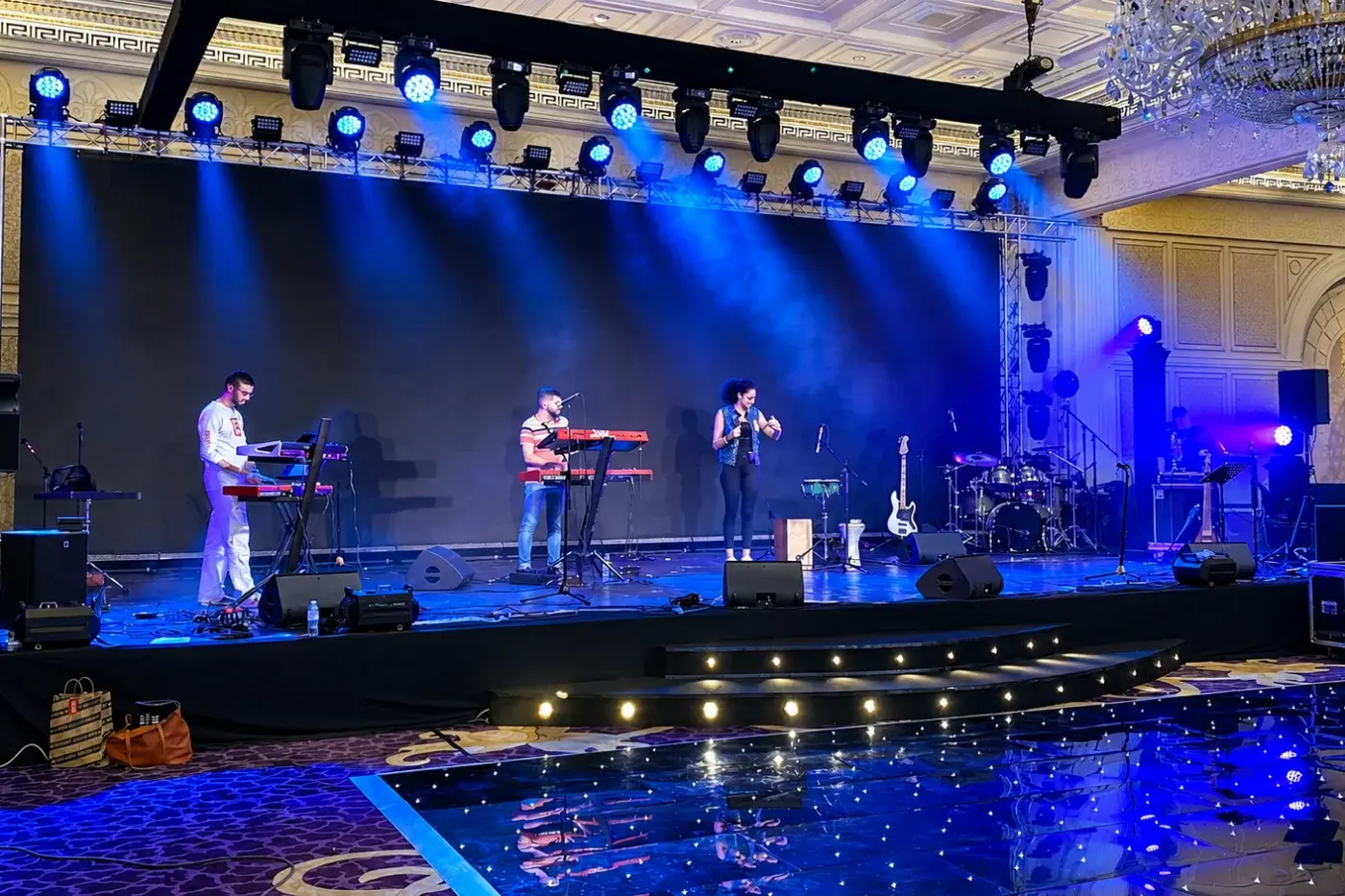 Open-air stage with side screens and stage lighting for a live performance