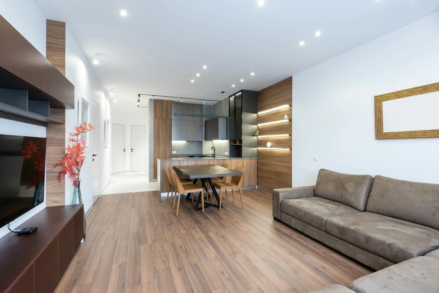 Modern open-plan living room with stylish kitchen and minimalist furniture design.