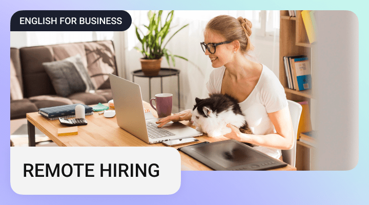 An attractive woman with a cat working on a laptop from home