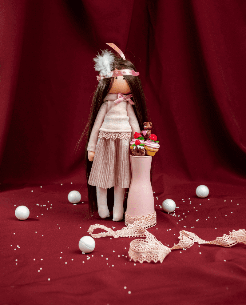 DIY textile sewing doll kit with pink bow and clothes and a cupcake tray