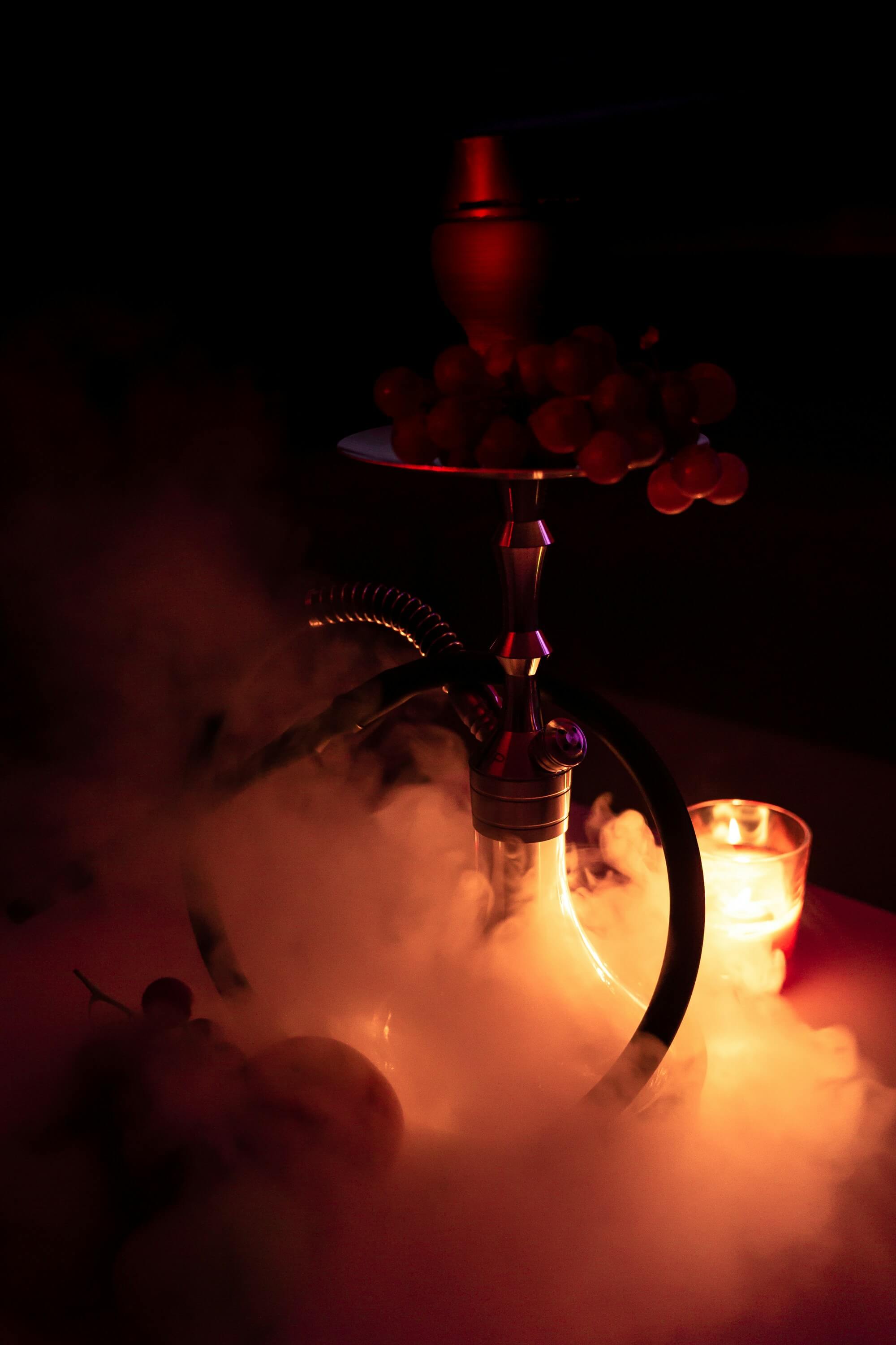 A thick cloud of aromatic hookah smoke rising from a beautifully crafted hookah.