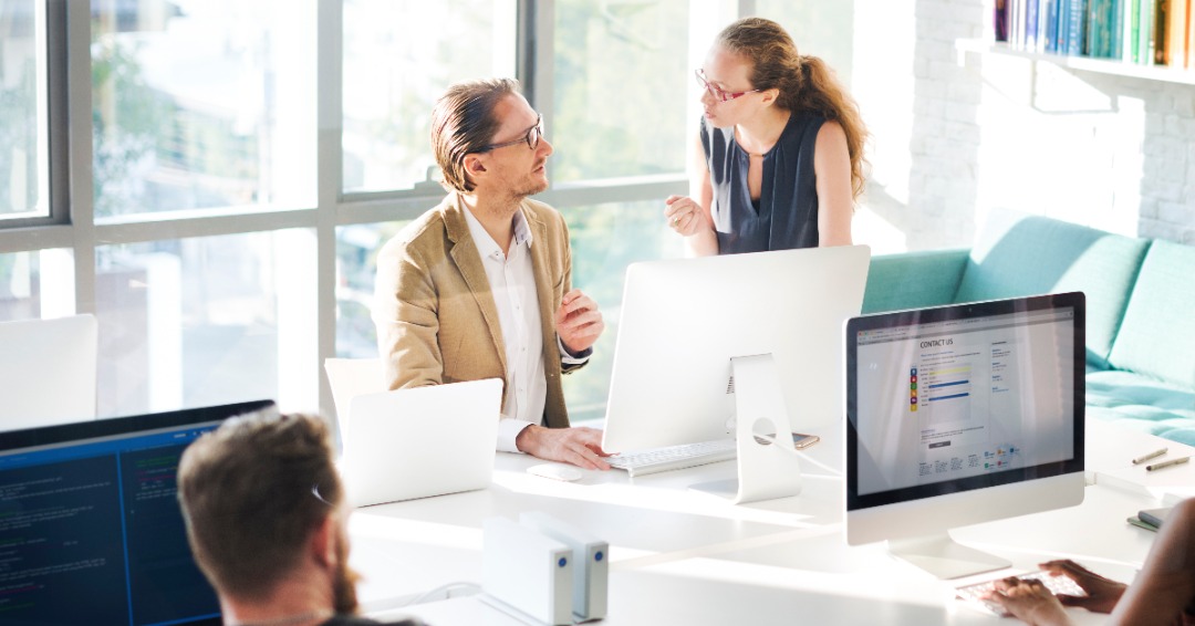 Colleagues talking in an office