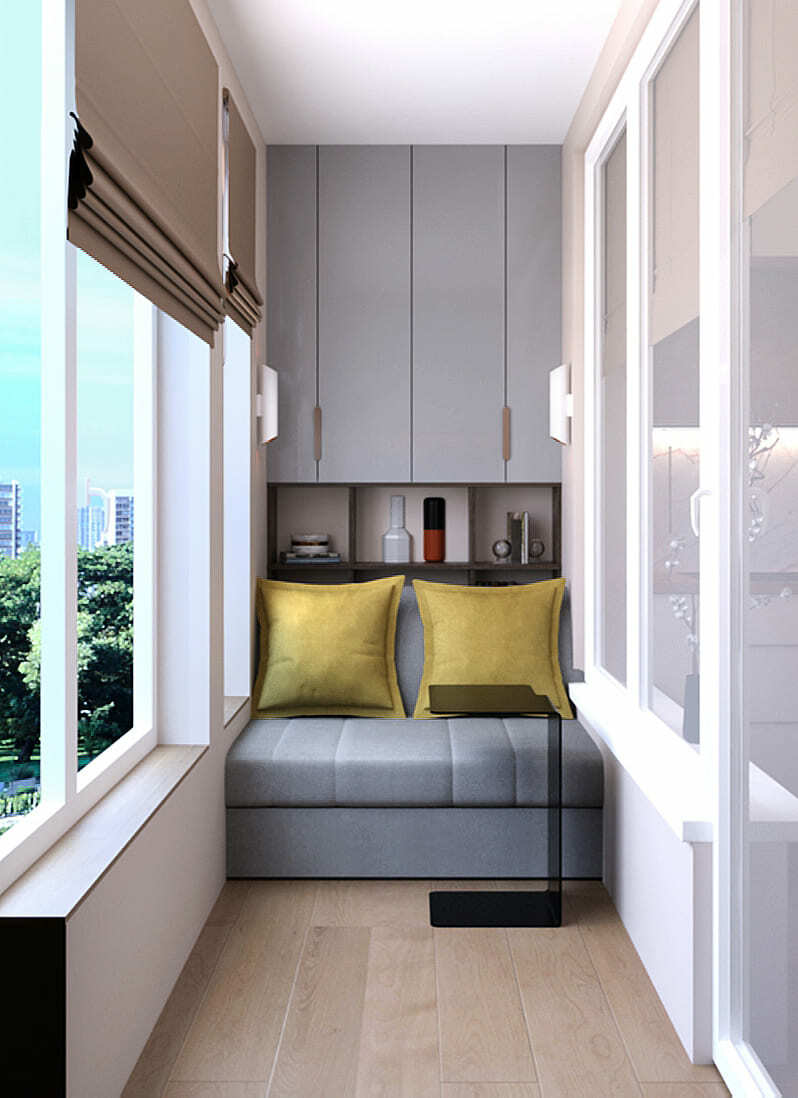 дизайн утеплённой лоджии с диваном, жёлтыми подушками, шкафом, римской шторой