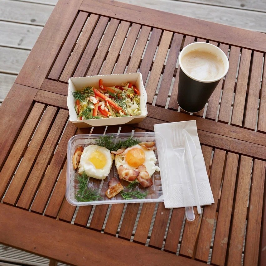 Breakfast on the deck at Ostrov Glamping: eggs, bacon, salad and coffee