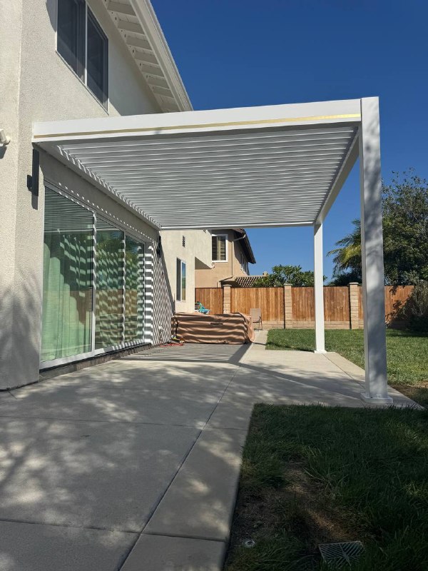 Adjustable aluminum pergola louvers over Huntington Beach outdoor patio
