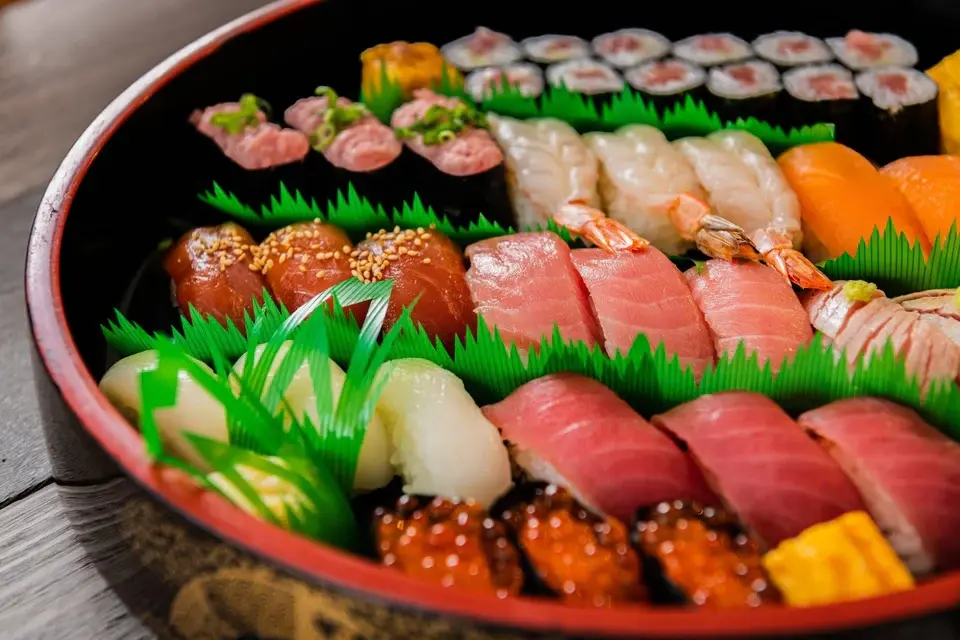 A close-up look at a large platter of traditional Japanese sushi, including various maki rolls, nigiri, and fresh seafood selections, illustrating the different types of sushi available in Seminyak.