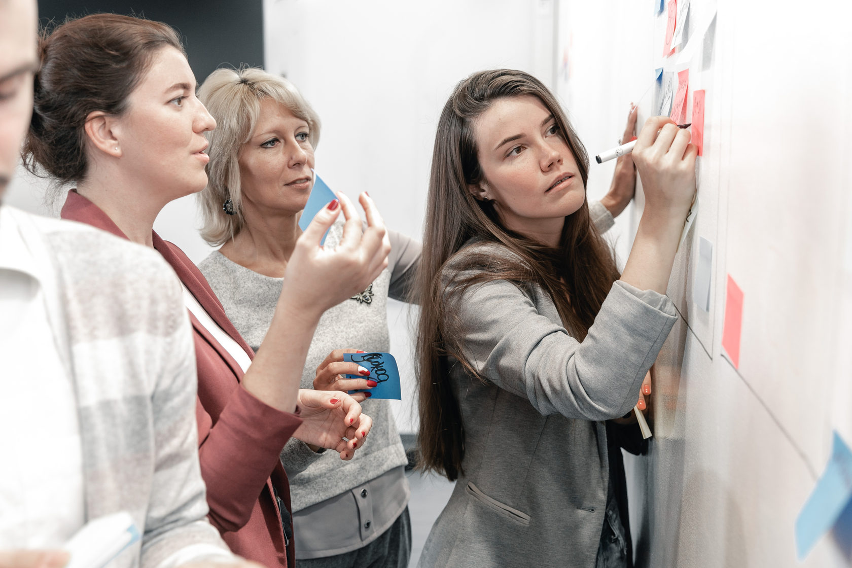 девушка пишет на стикере возде доски