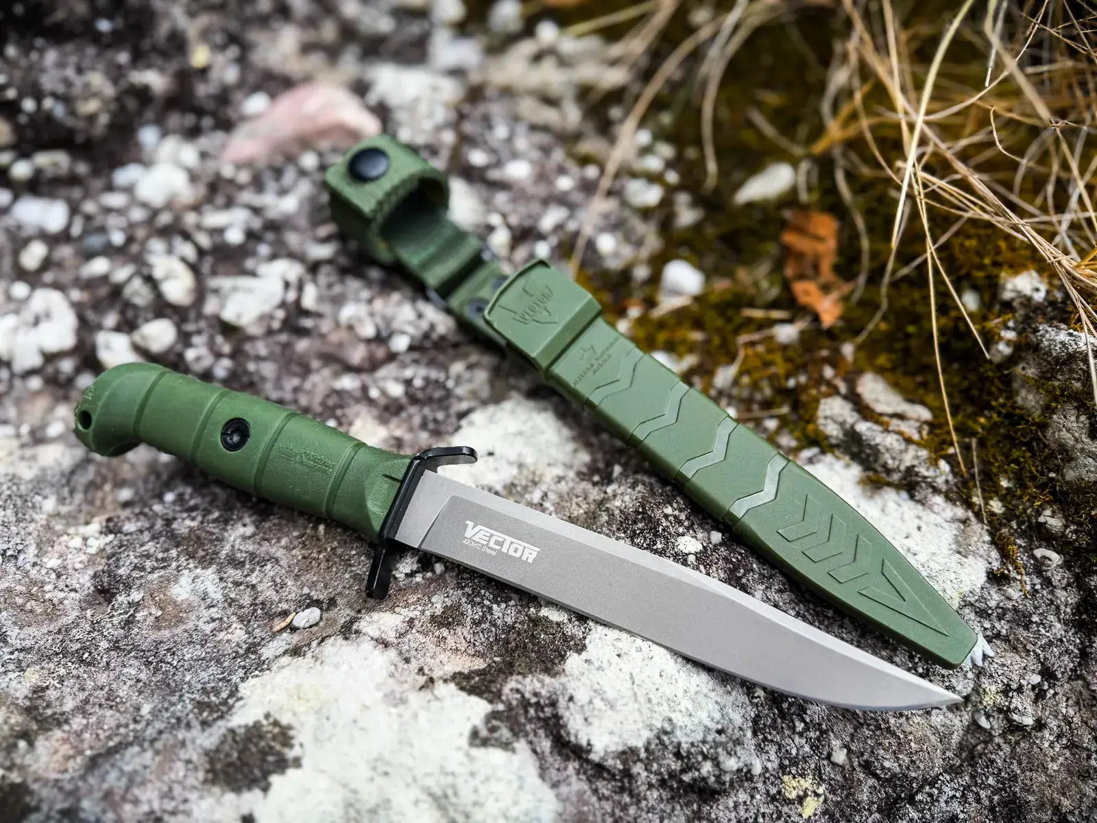 Olive Kizlyar Supreme Vector and matching sheath on mountain rock