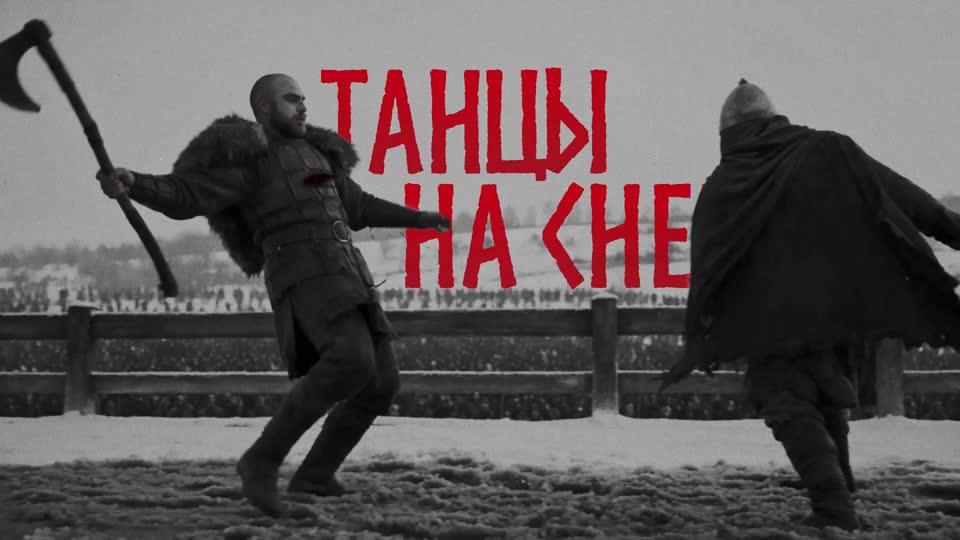 Кадр клипа: викинг замахивается топором, поверх кадра красная строка «Танцы на снегу»