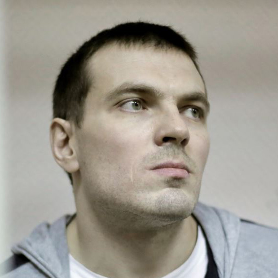 (9) Maxim Luzyanin was arrested on May 28, 2012. He was charged under 2.212 (“mass riots”) and 1.318 ( “the use of violence against a government representative”) of the Criminal Code. On November 9, 2012, he was sentenced to 4 years and 6 months. He served his sentence in Penal Colony-6 in Tula and is now on parole. ~