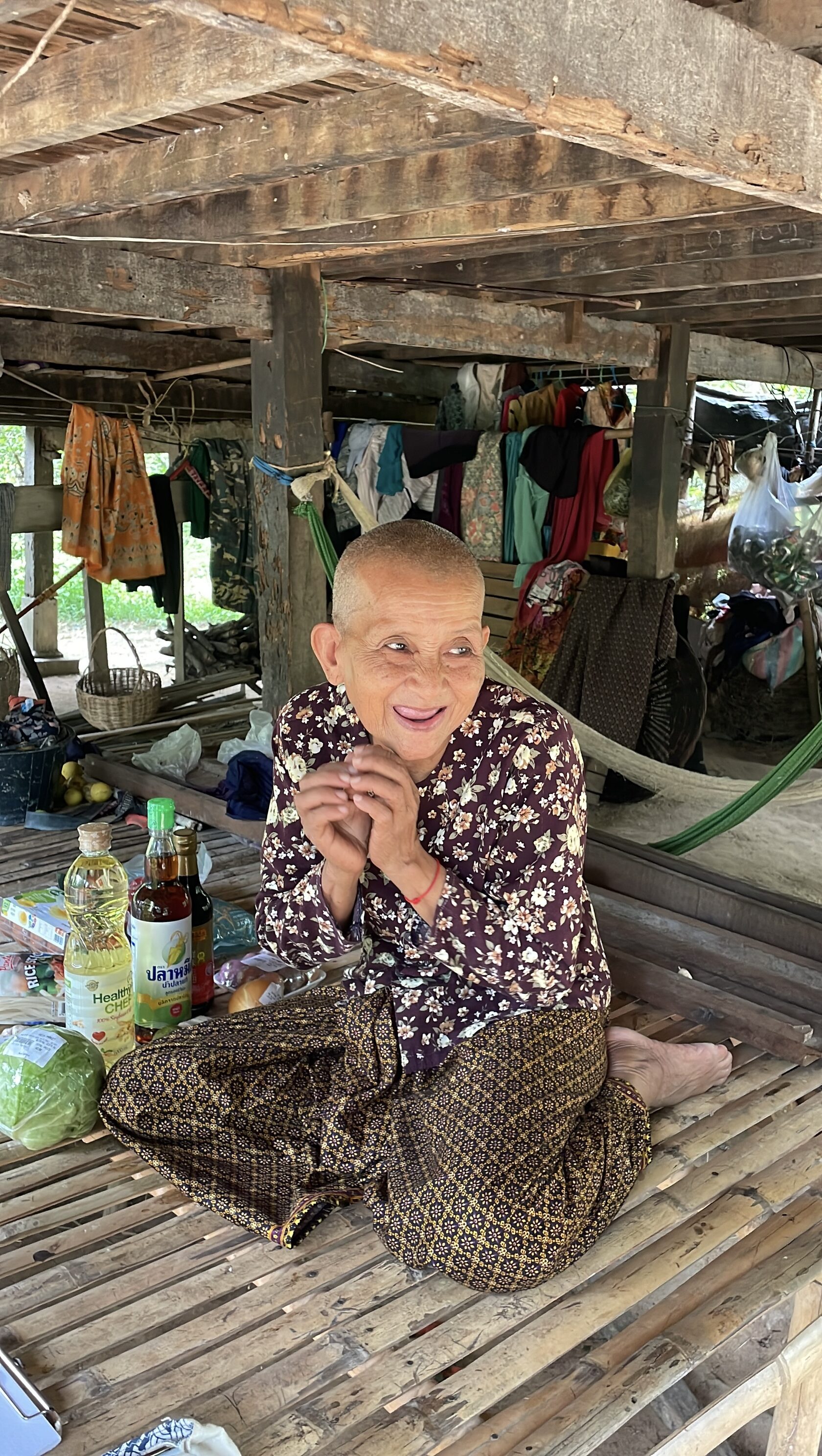 Elderly people in a rural Cambodian village receiving food and care