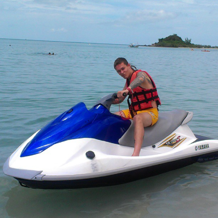 tattooed man on a jet ski